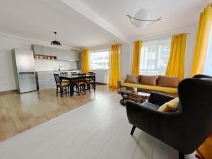 a living room with a couch and a table at YamaLuxe Apartments - WestSide 2 in Floreşti