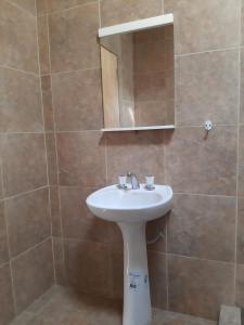 a bathroom with a white sink and a mirror at La Termenia in Termas de Río Hondo