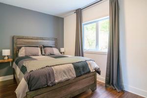 Un dormitorio con una cama grande y una ventana en Grands Espaces Orford 115 condo/chalet en Orford