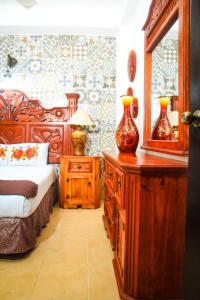 a bedroom with a bed and a dresser with a mirror at Palacio Canton in Valladolid