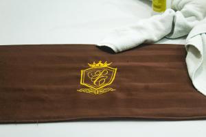 a brown towel with a crown logo on it at Palacio Canton in Valladolid