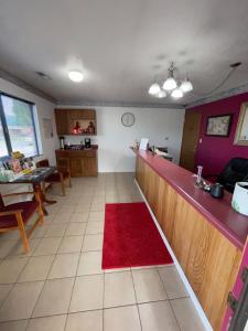 a kitchen with a red counter and a red rug at Executive Inn in Mountain Home