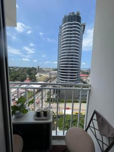 a balcony with a view of a tall building at Inspiria Condominium Tower, beside Abreeza Ayala Mall, Davao City in Davao City