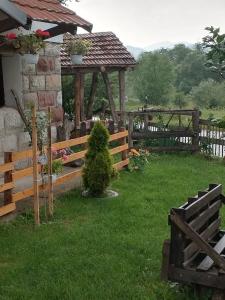 a garden with a wooden fence and a gazebo at VILA BOJANA in Inovo
