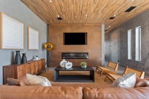 a living room with a couch and a tv at Black C House- Pool & Spa in Joshua Tree