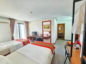 Rúm í herbergi á Le Botum Hotel