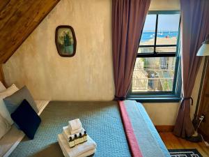 a bedroom with a bed with a large window at Crew's Quarters Boarding House - Caters to Men in Provincetown