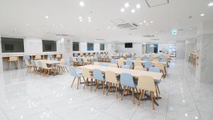 a room with rows of tables and chairs in it at Toyoko Inn Osaka Namba in Osaka