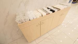 a shelf with white towels on it in a store at Toyoko Inn Osaka Namba in Osaka