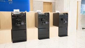 three vending machines are on display in a room at Toyoko Inn Osaka Namba in Osaka