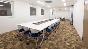 a conference room with a long table and chairs at Toyoko Inn Osaka Namba in Osaka