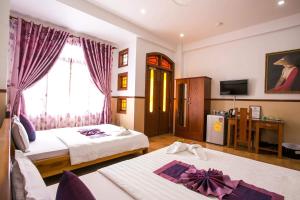 Postel nebo postele na pokoji v ubytování Hoa My II Hotel