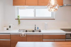 a kitchen with a sink and a window at Lampstand STAY Sapporo-House A in Sapporo +55 photos