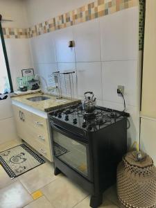 a kitchen with a stove and a sink at Refúgio Linda Vista in Canela