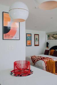 a bedroom with a red chair and a bed at Retro Retreat - by Coast Hosting in Terrigal