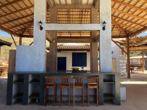 a bar in the center of a house with chairs at Estância do Biribiri in Diamantina