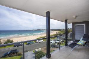 a balcony with a view of the beach and the ocean at Beach Road in Mollymook