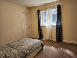a bedroom with a bed and a window at Entire home near Hamilton in Caledonia