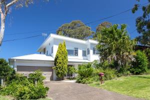 a white house with trees in front of it at Bombora Pearl in Mollymook