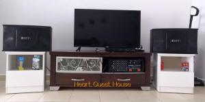 a entertainment center with a flat screen tv and two speakers at Heart Bentong Guest House 文冬心宿民宿 Bentong Homestay in Bentong