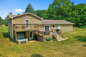 a large house with a deck and a yard at LAKEFRONT PARADISE 4 bedroom Home w direct lake access, Pets OK in Traverse City