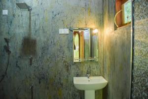 a bathroom with a sink and a mirror at Kirindioya Village in Tanamalwila