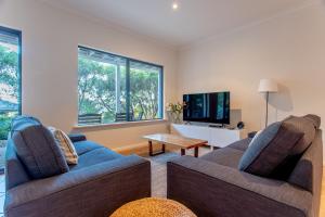 a living room with two couches and a tv at Sea Spell I Private Properties in Dunsborough