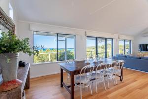 a dining room with a table and chairs and a couch at Sea Spell I Private Properties in Dunsborough +31 photos