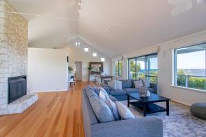 a living room with a couch and a fireplace at Sea Spell I Private Properties in Dunsborough