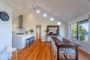 a kitchen and living room with a table and chairs at Sea Spell I Private Properties in Dunsborough