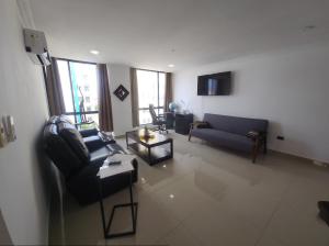 a living room with a couch and a table at Ubicacion y comodidad en una Suit in Manta