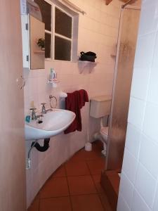 a bathroom with a sink and a toilet at Anchor Aweigh Chalet 86 in Hibberdene