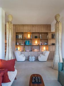 a living room with two white couches and a table at La Serena Hotel FDM in Forte dei Marmi