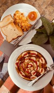 a table with a plate of food with shrimp and toast at Villa Thavisouk Legend - Luang Prabang in Luang Prabang