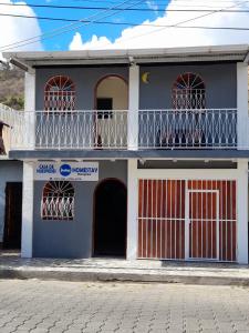 a blue and white house with a balcony at Homestay Matagalpa in Matagalpa