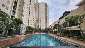 a swimming pool in a city with tall buildings at Amazing view Apartment at Kemayoran JIEXPO -Min Stay 3 nights- in Jakarta