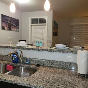 a kitchen with a sink and a counter top at Stylish and Spacious, close to the Hospital. in Fort Wayne