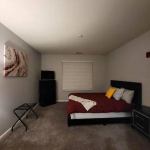 a bedroom with a bed and a window in it at Stylish and Spacious, close to the Hospital. in Fort Wayne
