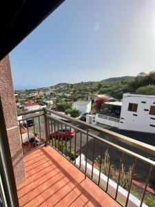 a balcony with a view of a city at Casa La Asomada El Hierro in Las Casas