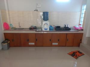 a kitchen with a counter with a sink and a stove at OYO 92879 Imperial Inn in Cilacap
