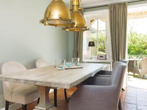 a dining room with a large wooden table and chairs at Prahl-Hues-2 in Kampen