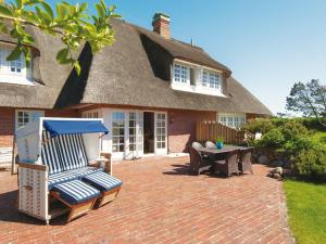 a patio with chairs and a table in front of a house at Rasmus-5 in Kampen