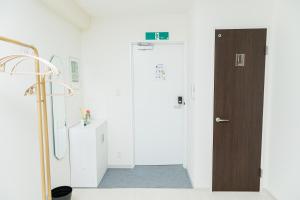 a hallway with a door in a room at Cocone House Tengachaya Family suite room in Osaka +53 photos