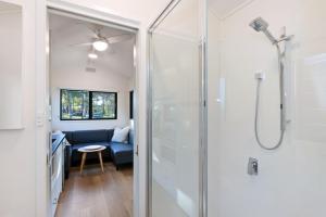 a bathroom with a shower with a glass door at Reflections Moonee Beach - Holiday Park in Moonee Beach