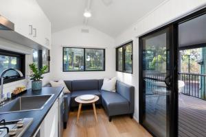 a kitchen and living room of a tiny house at Reflections Moonee Beach - Holiday Park in Moonee Beach +44 photos