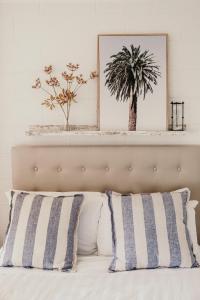 a bedroom with a bed with striped pillows at Sweet Tide O Moyne in Port Fairy +21 photos
