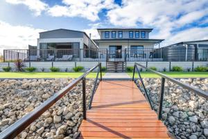 a home with a staircase leading to a house at TheRiverbend43 Wellington Marina in Wellington East