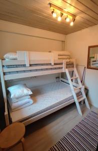 two bunk beds in a room with a table at Maggala apartments in Utsjoki