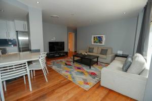 a living room with a couch and a table at Har 55 3 bedroom Self-Catering in Sydney