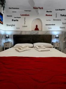 a bed in a room with a wall with names at Suite SAN GENNARO in Naples